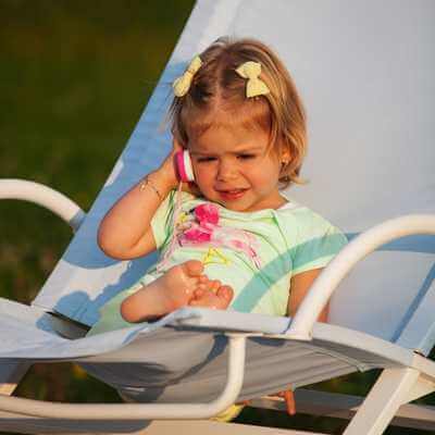 little girl talking on a toy phone after having called her parents phone number