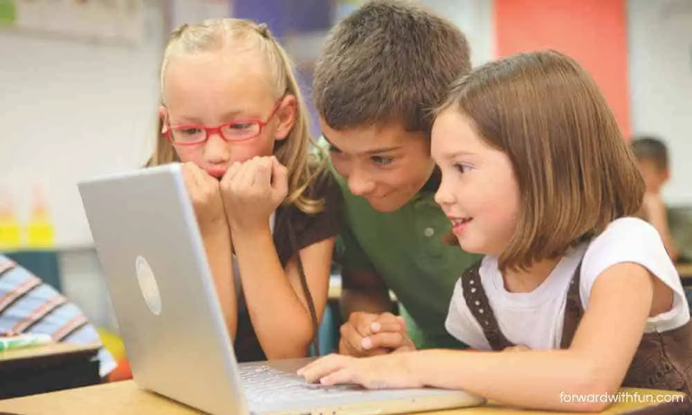 three children surrounding a computer 